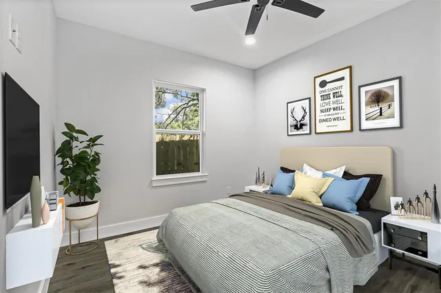 a bedroom with a bed and a potted plant