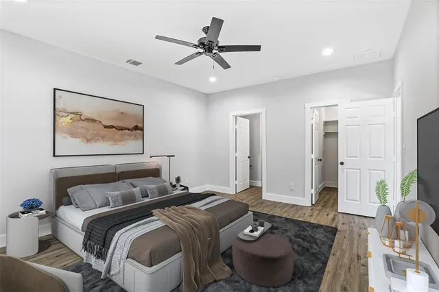 a bedroom with a bed and glass walk in closet