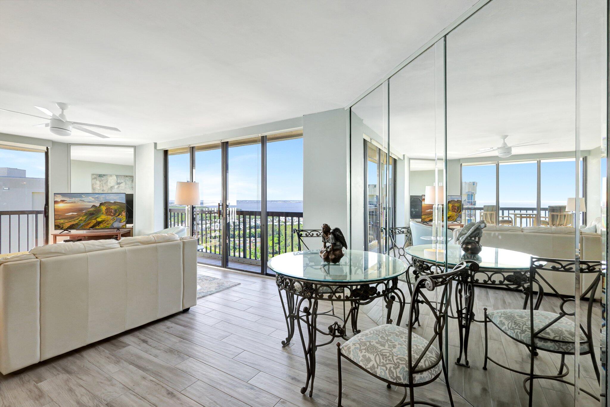 9500 South Ocean Drive, Unit PH10 Jensen Beach, FL 34957 - Photo 16 of 41 a dining room with furniture a chandelier and wooden floor