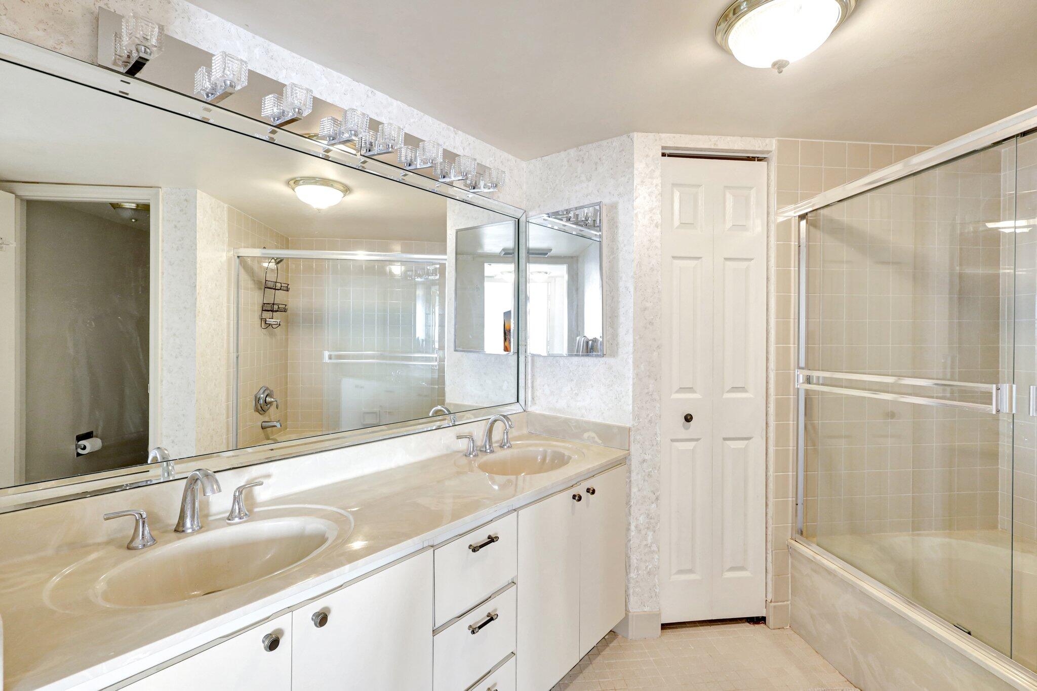 9500 South Ocean Drive, Unit PH10 Jensen Beach, FL 34957 - Photo 26 of 41 a bathroom with a granite countertop sink mirror and a bathtub