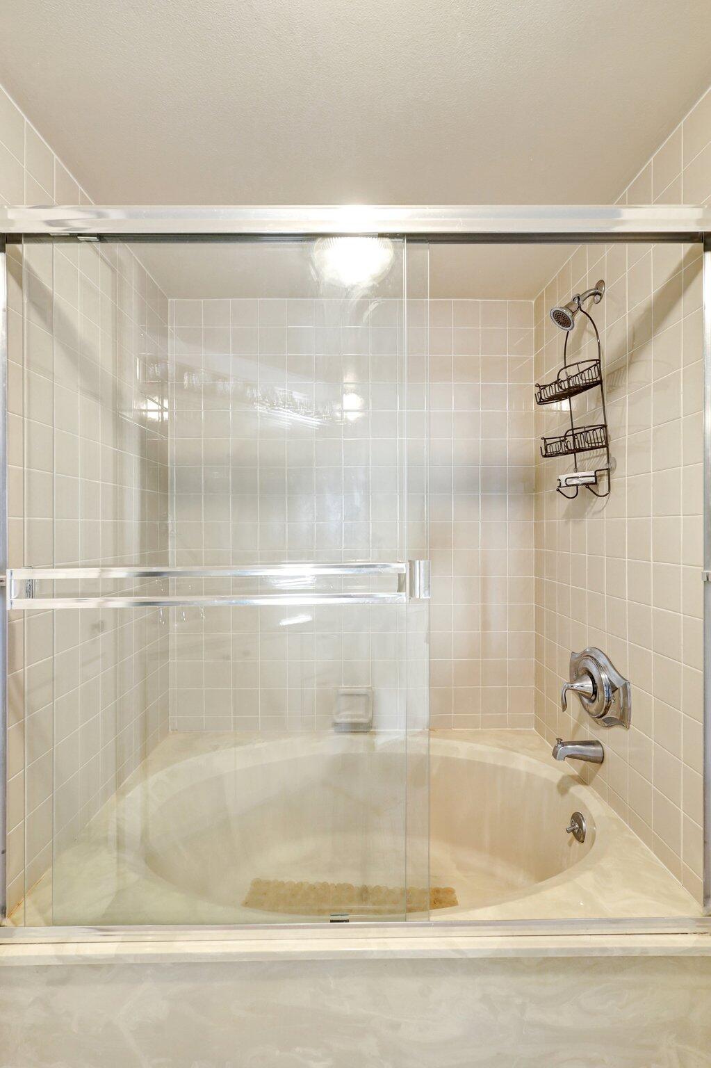 9500 South Ocean Drive, Unit PH10 Jensen Beach, FL 34957 - Photo 27 of 41 a bathroom with a shower and a bath tub