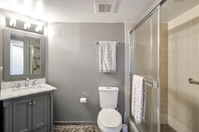 a bathroom with a toilet a sink and a mirror