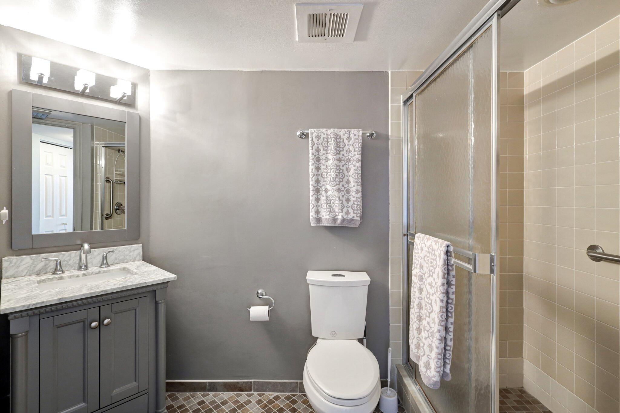 9500 South Ocean Drive, Unit PH10 Jensen Beach, FL 34957 - Photo 32 of 41 a bathroom with a toilet a sink and a mirror