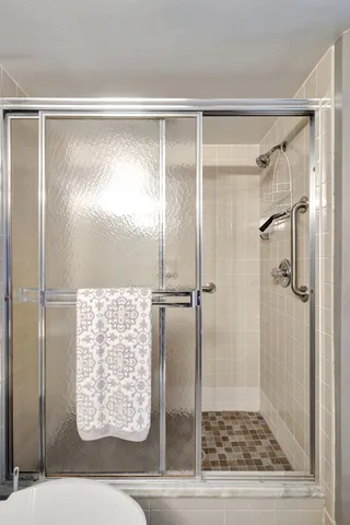 a bathroom with a glass shower door