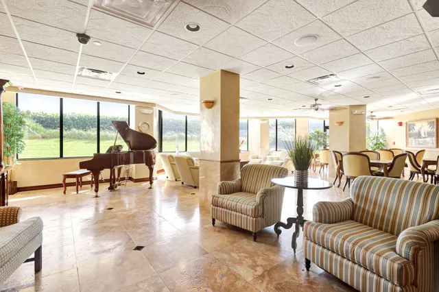 a living room with furniture and a large window with outer view