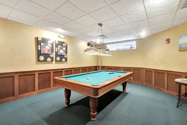 a room with pool table and a chandelier
