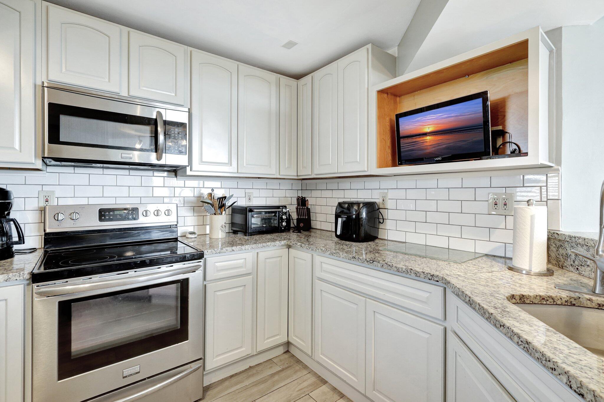 9500 South Ocean Drive, Unit PH10 Jensen Beach, FL 34957 - Photo 7 of 41 a kitchen with stainless steel appliances a stove microwave and sink