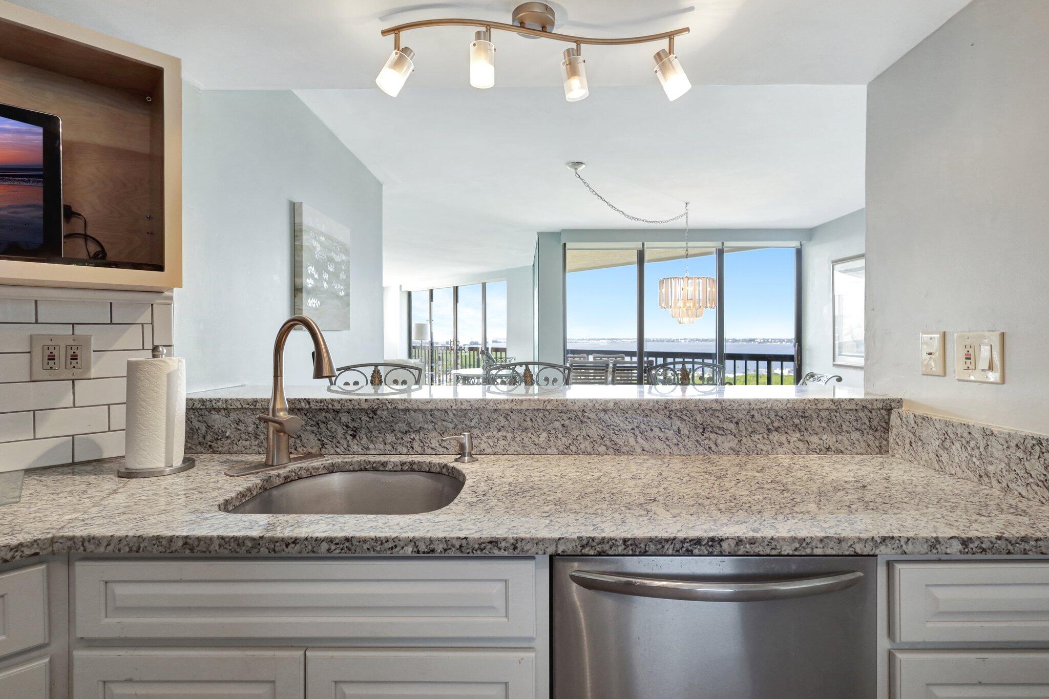 9500 South Ocean Drive, Unit PH10 Jensen Beach, FL 34957 - Photo 8 of 41 a kitchen with granite countertop stainless steel appliances granite countertop a sink and a granite counter tops