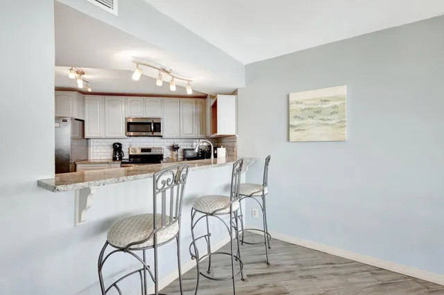 a kitchen with stainless steel appliances a refrigerator and microwave