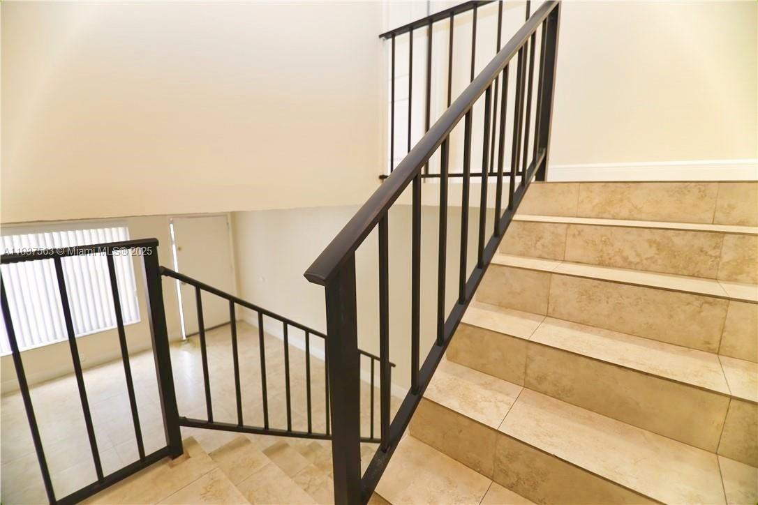 1654 Northeast 151st Street Miami, FL 33162 - Photo 11 of 19 a view of staircase with lots of floor and white walls