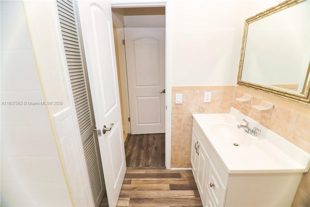 1654 Northeast 151st Street Miami, FL 33162 - Photo 15 of 19 a bathroom with a sink a toilet and a mirror