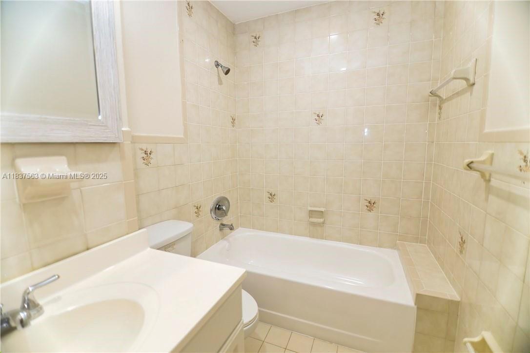 1654 Northeast 151st Street Miami, FL 33162 - Photo 17 of 19 a bathroom with a sink and a bathtub