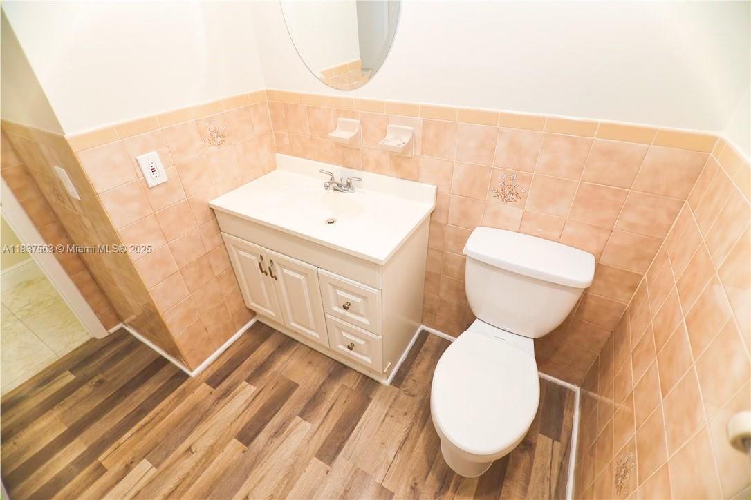 1654 Northeast 151st Street Miami, FL 33162 - Photo 8 of 19 a bathroom with a sink mirror and toilet