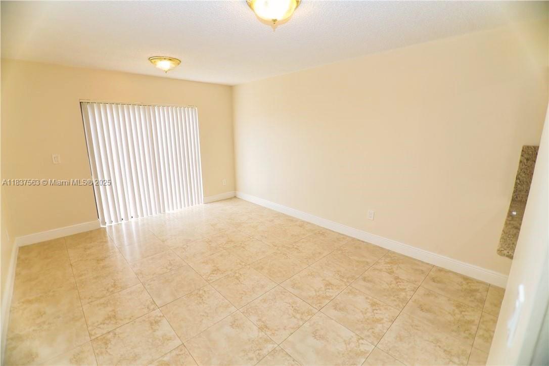 1654 Northeast 151st Street Miami, FL 33162 - Photo 10 of 19 an empty room with a natural light