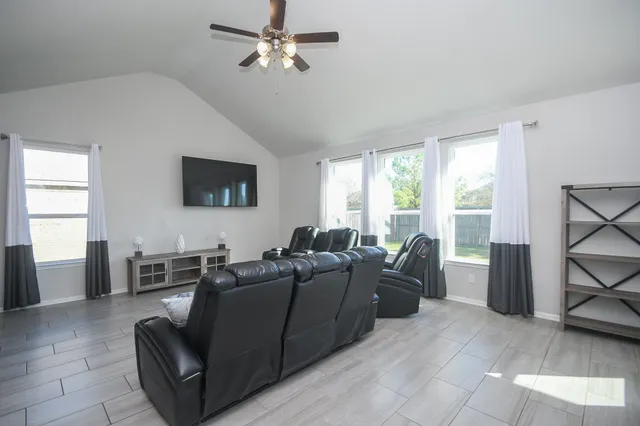 a bedroom with a bed a mirror and a window