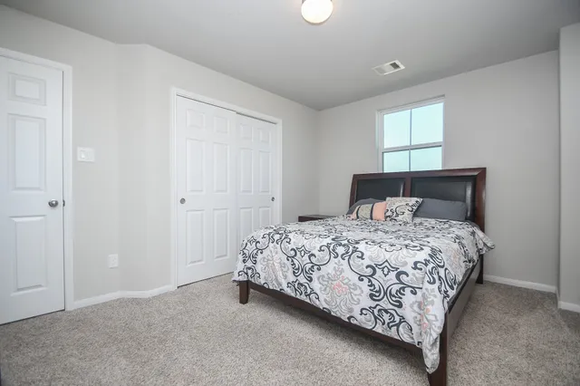 a bedroom with a bed and a dresser