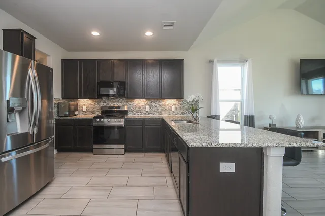 a kitchen with a stove and a sink