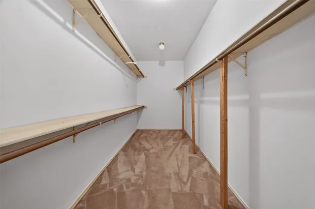 a kitchen with a white cabinets and a wooden floor