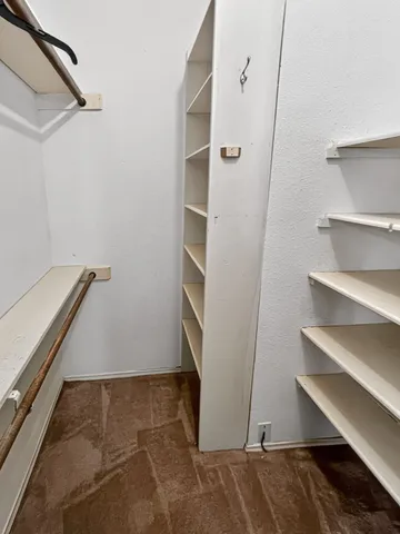 a view of an empty room with a chandelier