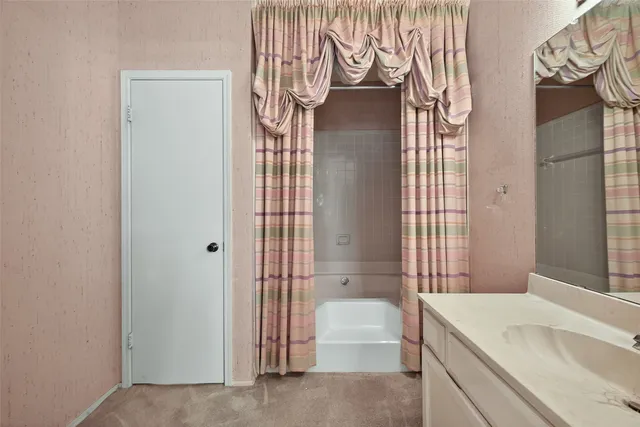 a bathroom with a glass shower door