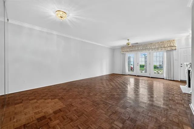 a view of an empty room with a fireplace and a window