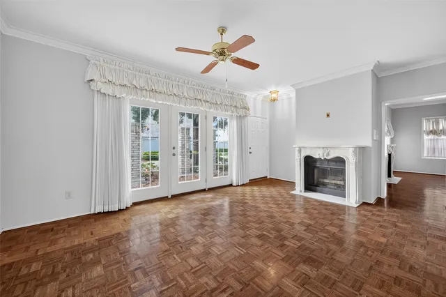 a view of empty room with window and ceiling fan