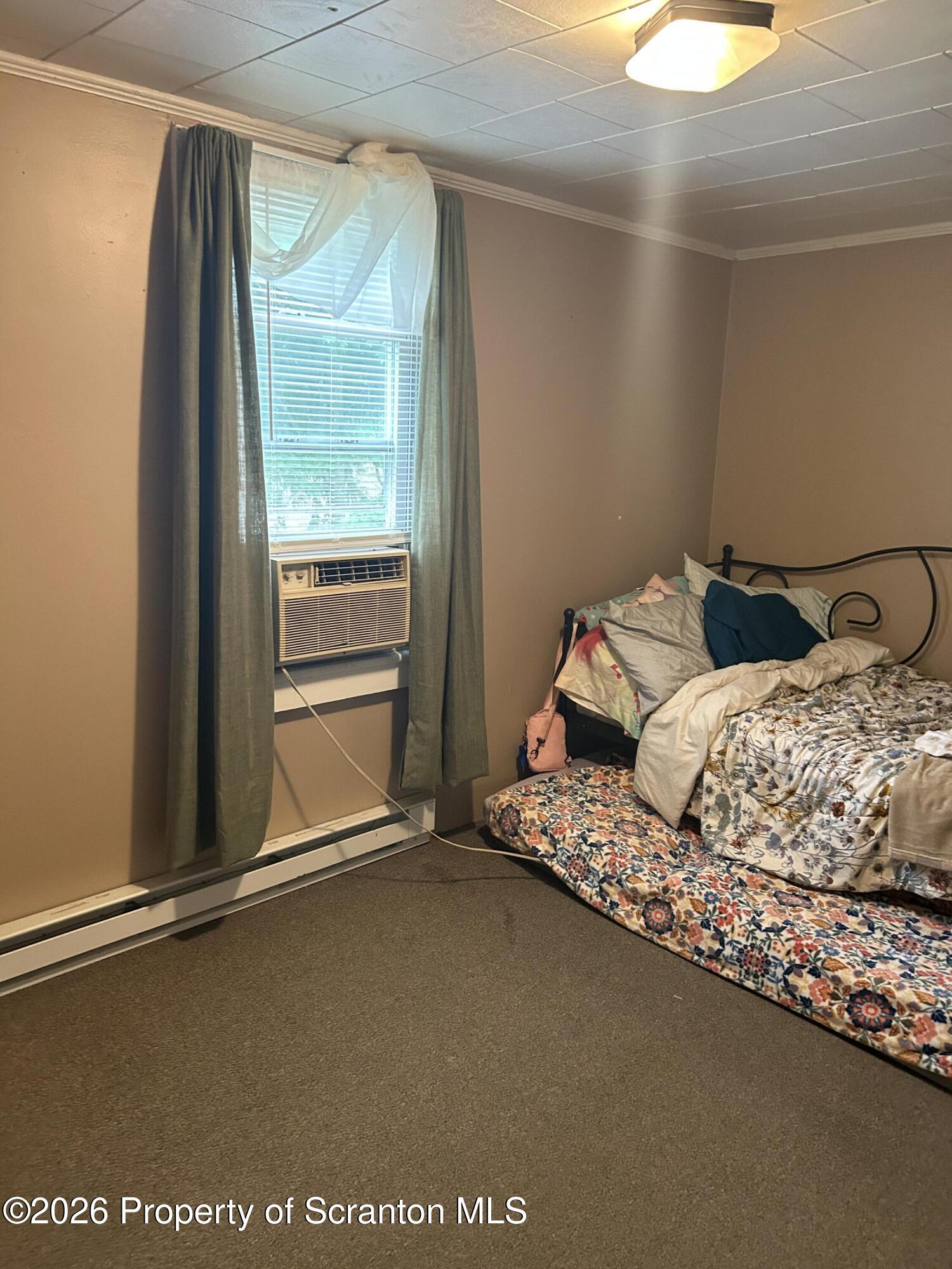 63 Shannon Street Simpson, PA 18407 - Photo 24 of 24 a bedroom with a bed and a window