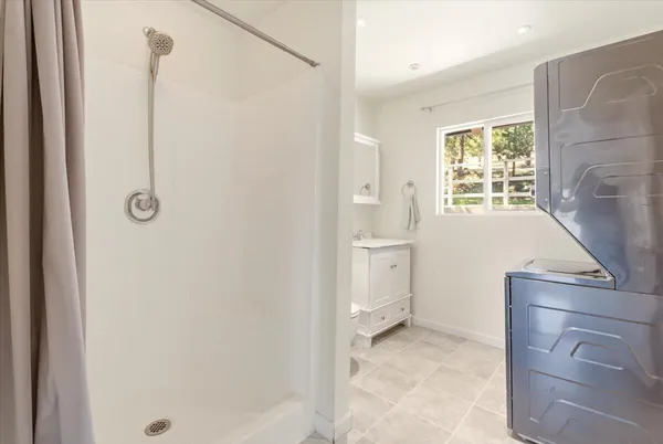 a bathroom with a granite countertop sink a toilet and shower