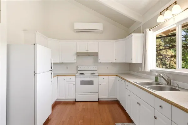 a kitchen with a sink a refrigerator and window