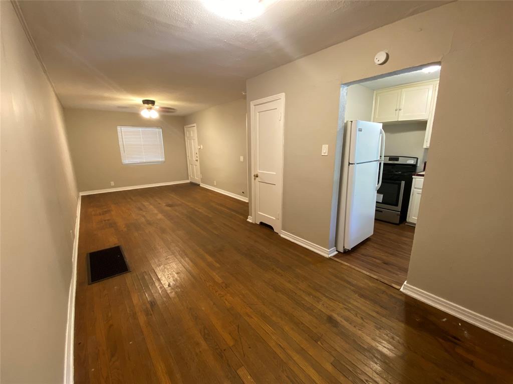 904 Denton Street Denton, TX 76201 - Photo 3 of 9 a view of a room with wooden floor and a window