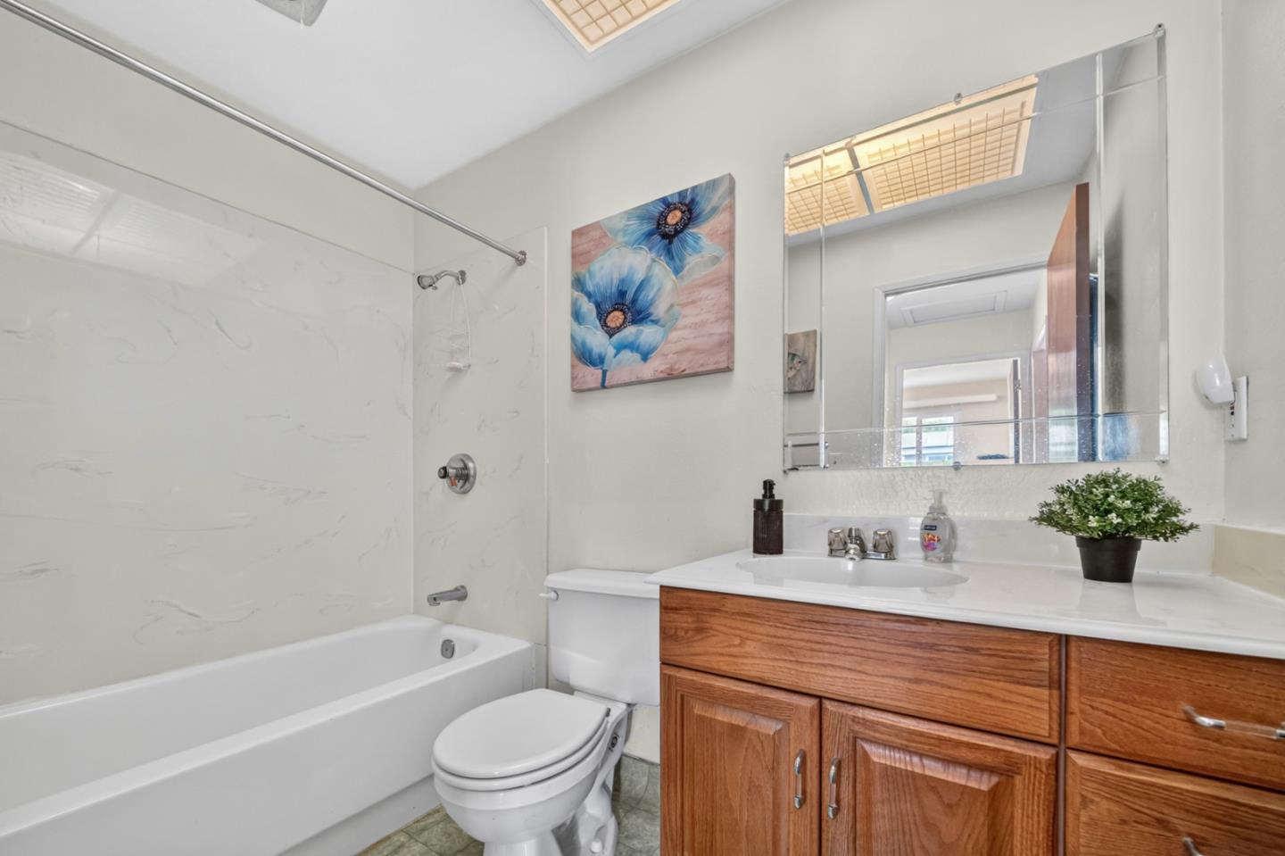 1287 Lerida Way Pacifica, CA 94044 - Photo 38 of 52 a bathroom with a tub a sink and a large mirror