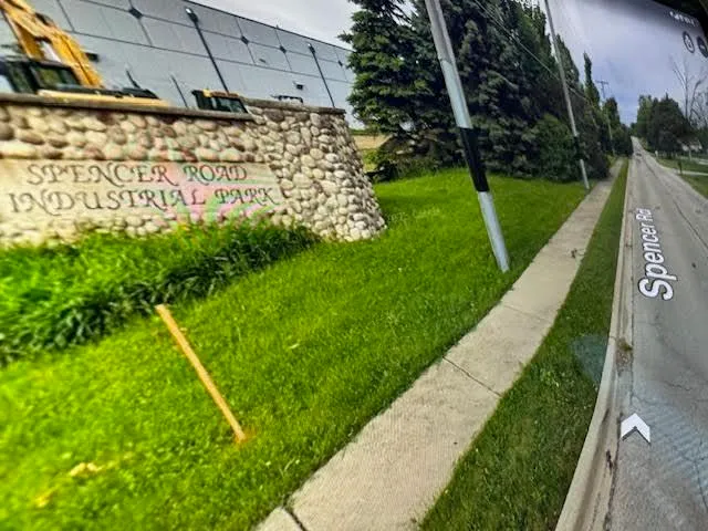 a view of a yard with potted plants
