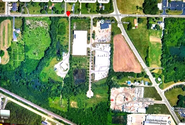 a view of a field with a tree in the background