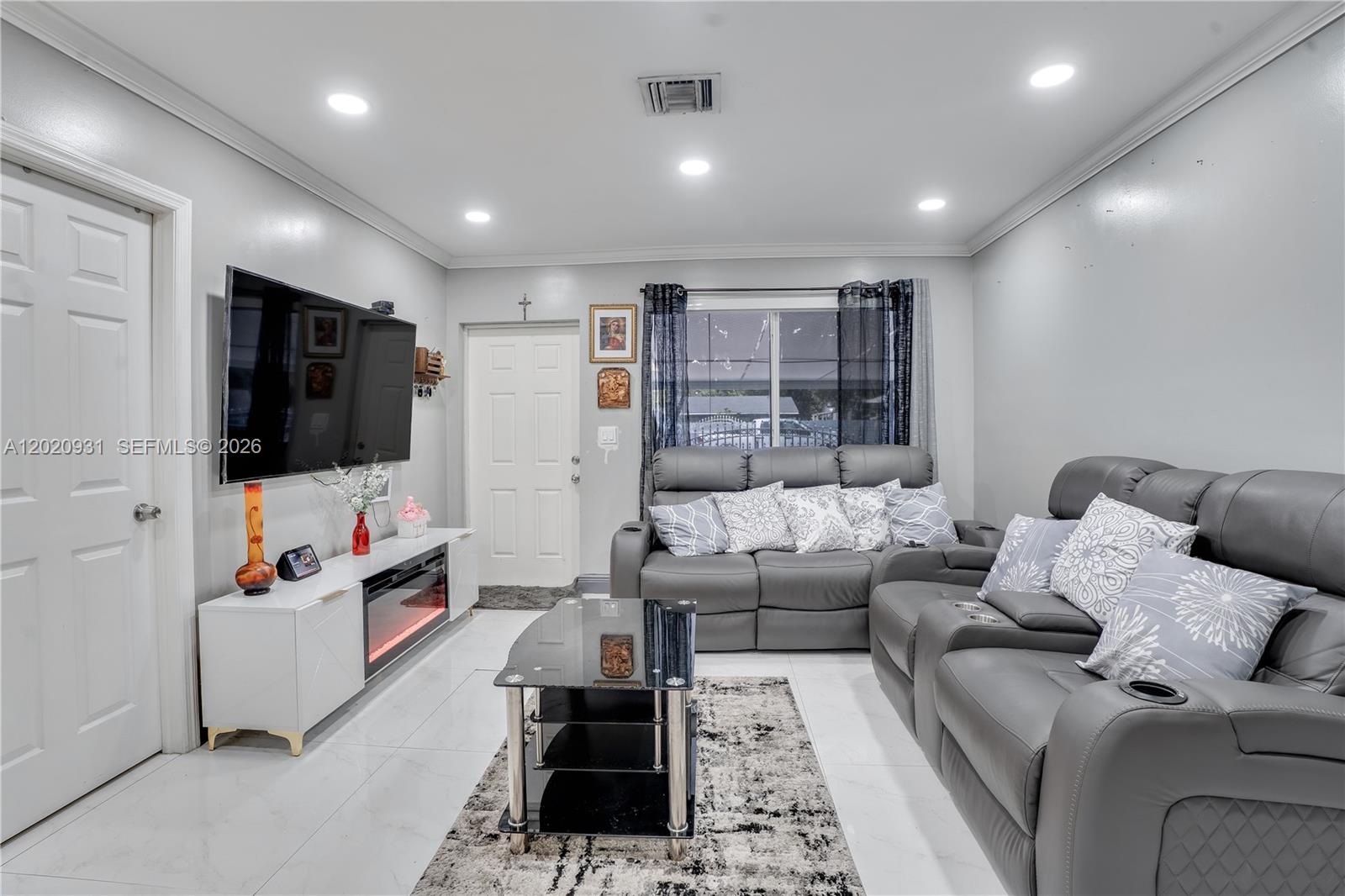 1360 Northwest 77th Street Miami, FL 33147 - Photo 6 of 41 a living room with furniture and a flat screen tv