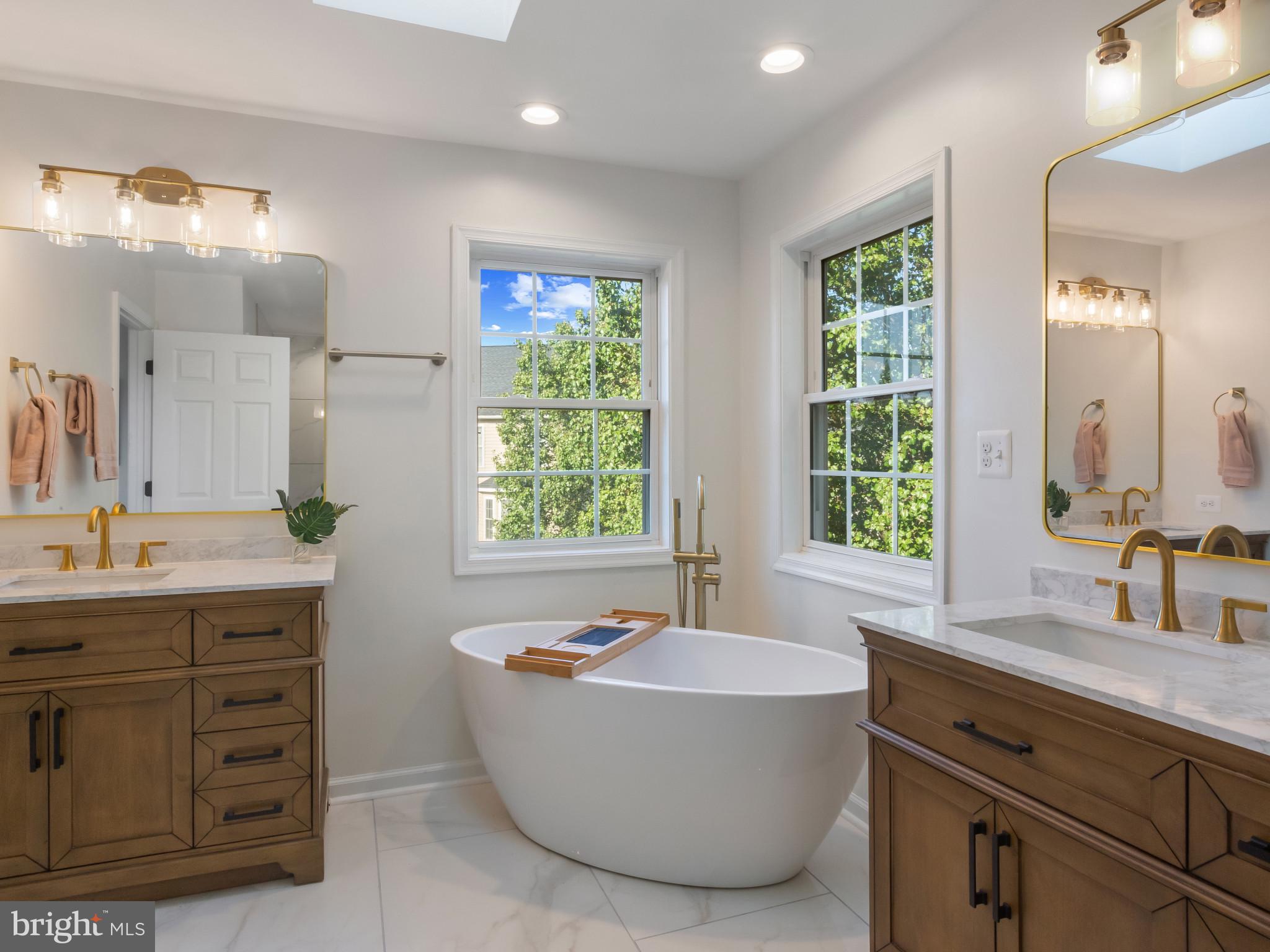 1612 Winesapp Drive Odenton, MD 21113 - Photo 17 of 34 a bathroom with a tub sink double vanity granite and a sink