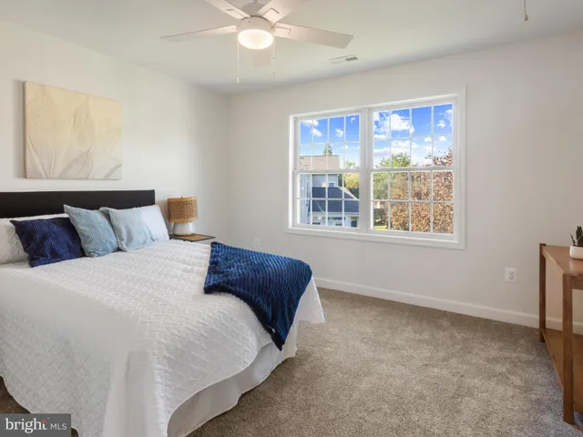 a bedroom with a large bed and a window