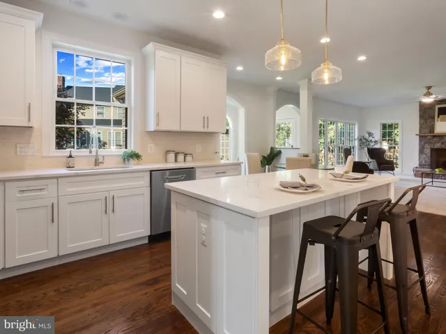 a kitchen with a sink dining table and chairs