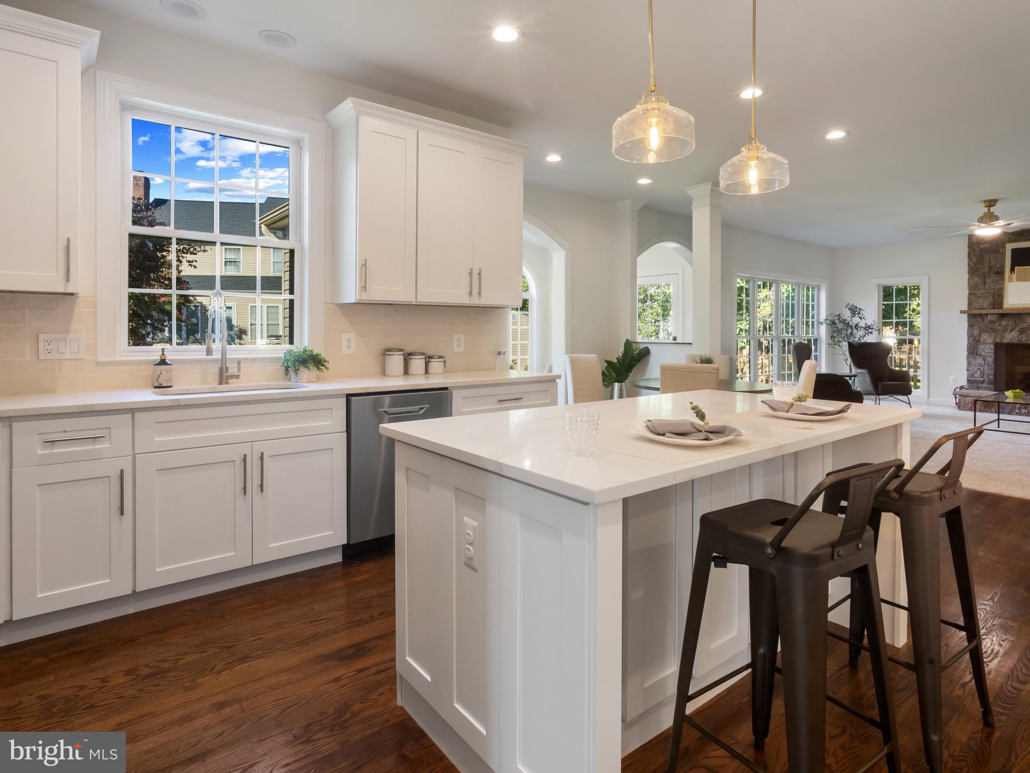1612 Winesapp Drive Odenton, MD 21113 - Photo 2 of 34 a kitchen with a sink dining table and chairs