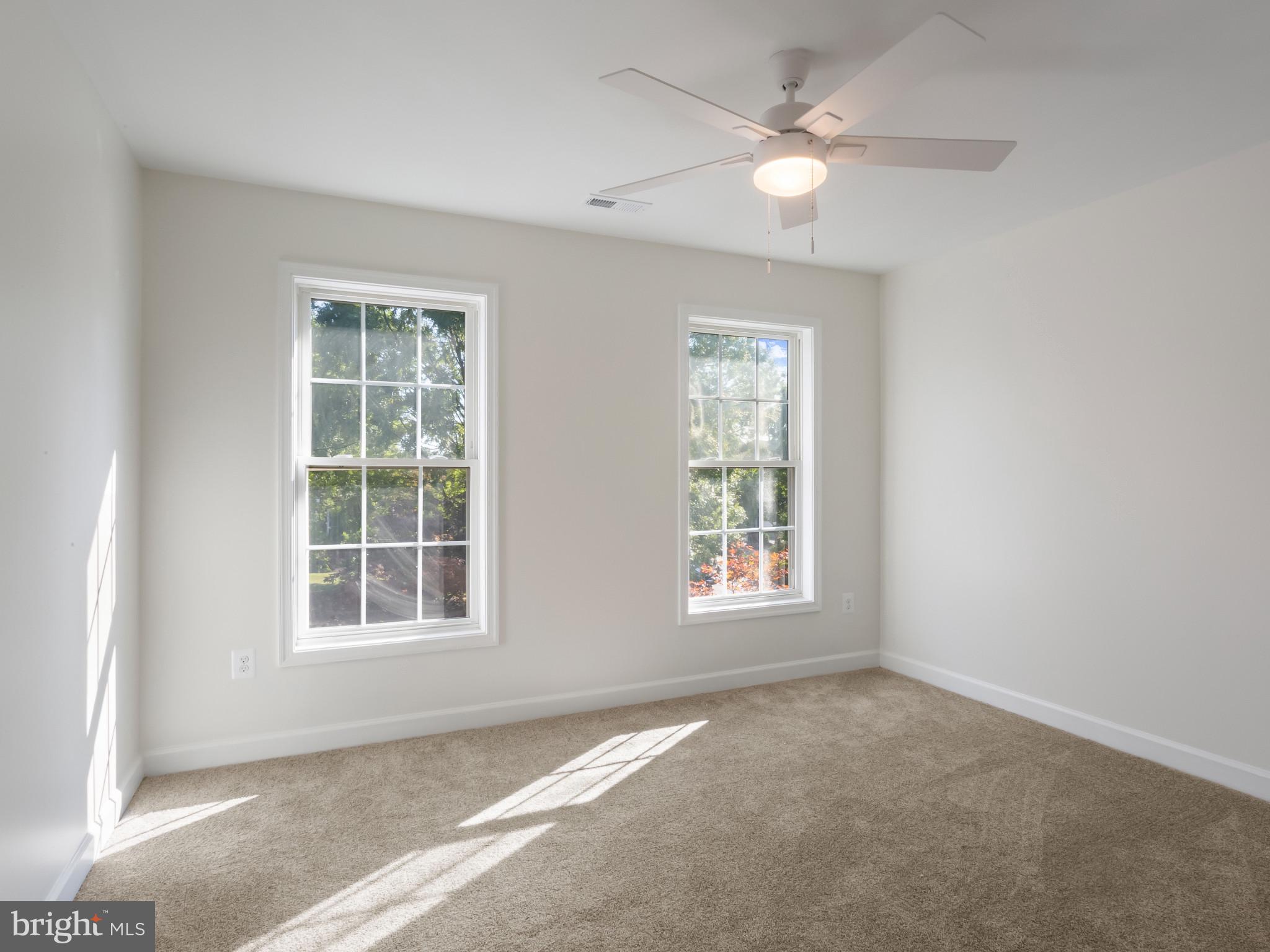 1612 Winesapp Drive Odenton, MD 21113 - Photo 22 of 34 an empty room with chandelier fan and windows