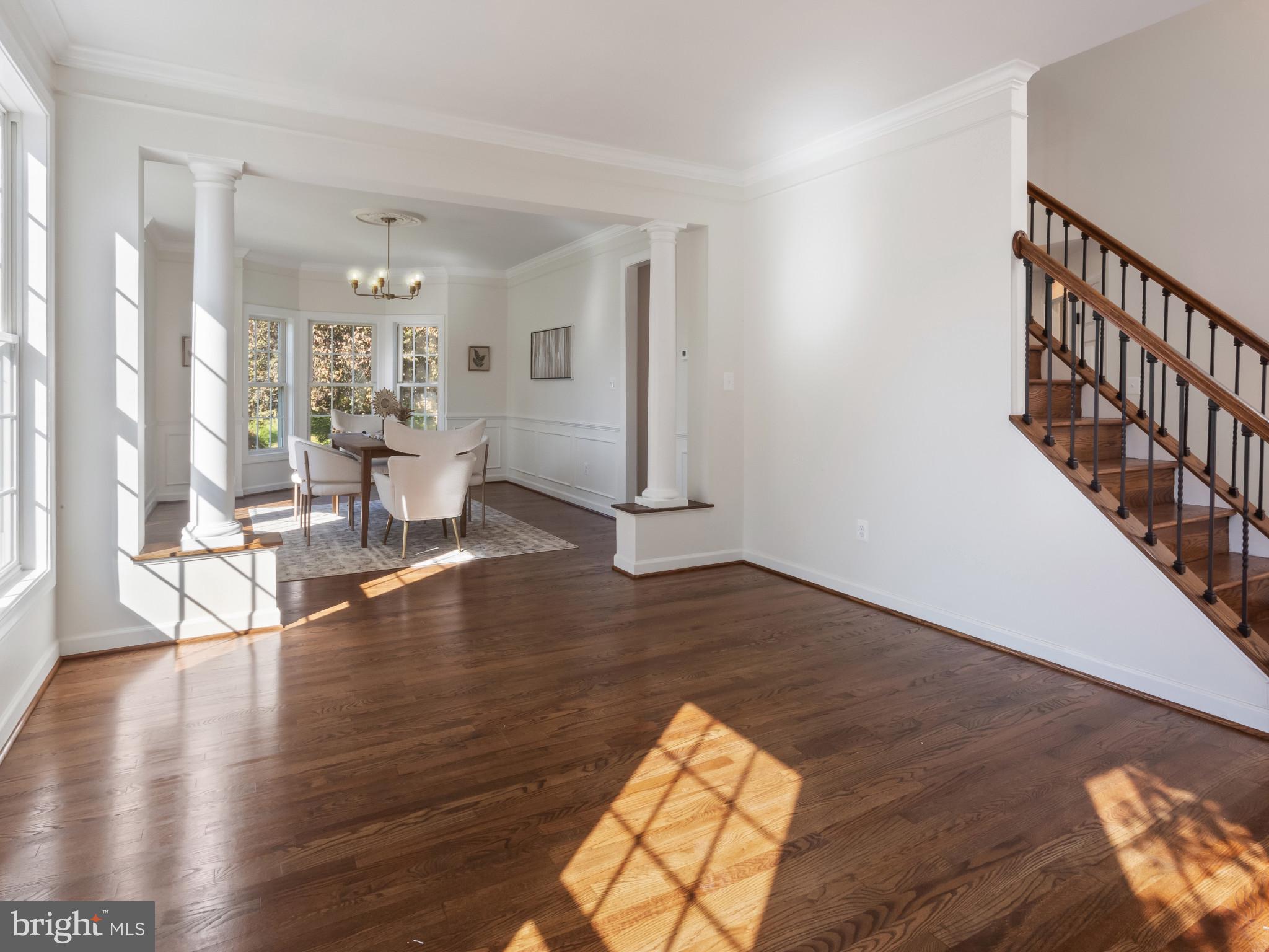 1612 Winesapp Drive Odenton, MD 21113 - Photo 7 of 34 a living room with furniture floor to ceiling window and wooden floor