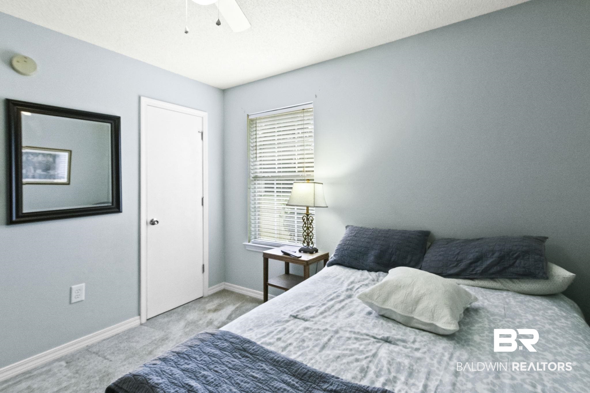 14031 Brook Hollow Road Summerdale, AL 36580 - Photo 37 of 56 Bedroom featuring ceiling fan and light carpet