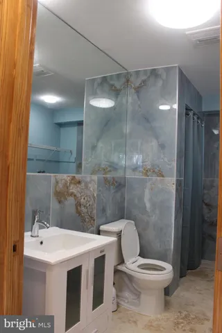 a bathroom with a sink toilet and shower