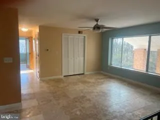 an empty room with windows and outdoor view