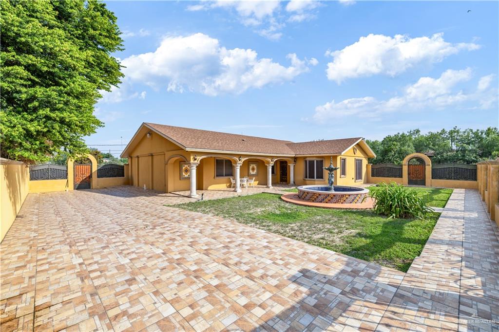 610 North Texas Street Rio Grande City, TX 78582 - Photo 2 of 23 a front view of a house with garden