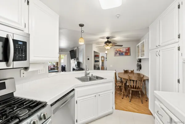 a kitchen with a sink and chairs