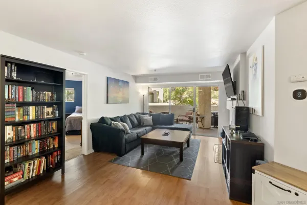 a living room with furniture and a book shelf