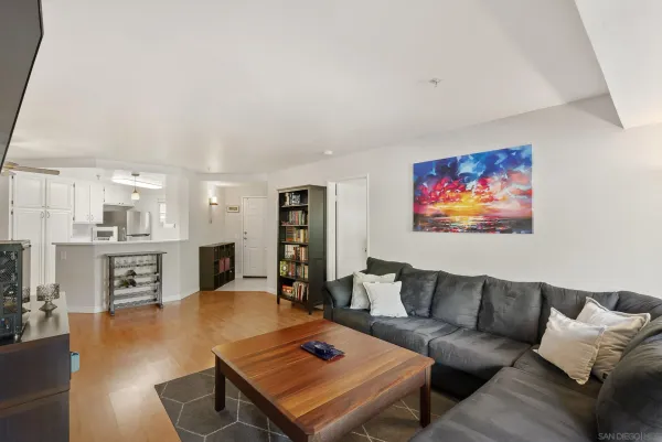 a living room with furniture kitchen view and a dining table