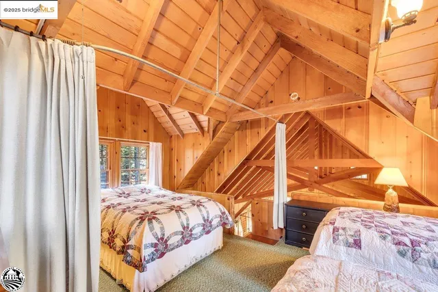 a bedroom with two beds and a window