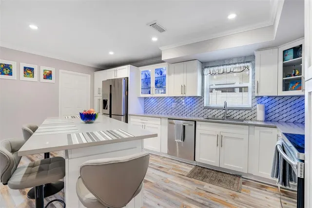 a open kitchen with stainless steel appliances granite countertop a sink and cabinets
