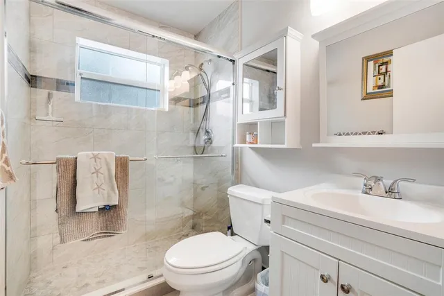 a bathroom with a sink toilet and shower